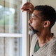 Man staring longingly out of window